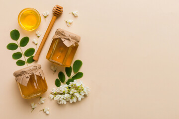 honey jar with acacia flowers and leaves. fresh honey top view flat lay © sosiukin