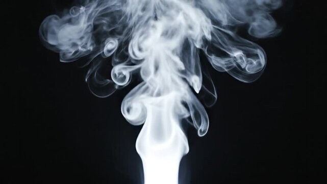 White Smoke Rising Against Black Background.