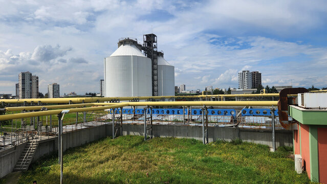 Anaerobic digesters in a municipal wastewater treatment plant, where sludge is decomposed in the absence of oxygen, producing methane (biogas)