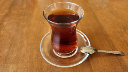 A traditional Turkish tea set, featuring a tulip-shaped glass called an ince belli and a small teaspoon.  © cilicia