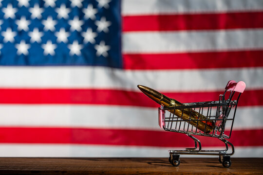Bullet placed in a miniature shopping cart against USA flag background symbolizing gun trade consumerism and political debate concept, closeup