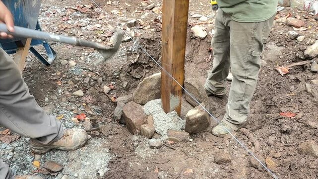 Adding cement into a post hole