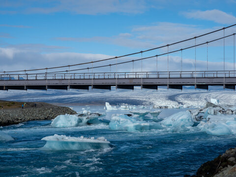Bridge carrying route 1 over Glacier Lagoon in Iceland with icebergs floating into the ocean