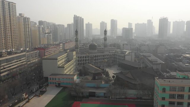 Drone flight towards large Dongguan mosque in residential neighborhood of Xining city in China
