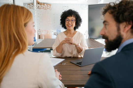 Real estate agent meeting with couple to sign contract for new house