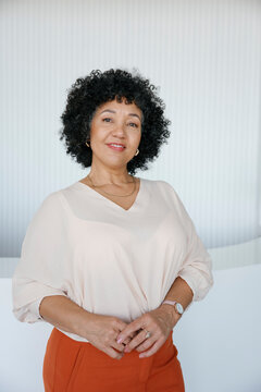 Confident businesswoman smiling in modern office portrait