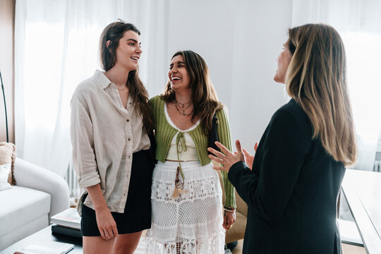 Lesbian couple consulting real estate agent during apartment viewing