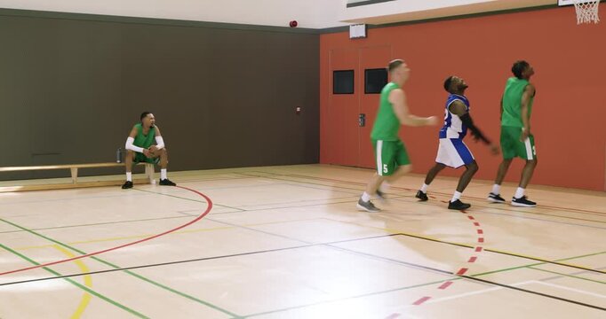 African american man number 12 dribbling basketball scanning court, faking pass, shooting, and divin