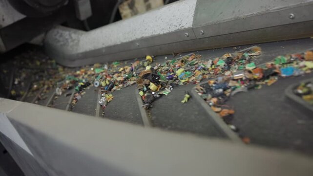 Dynamic Plastic Shards Move Along Highspeed Automated Conveyor Within Industrial Sorting Process . Media