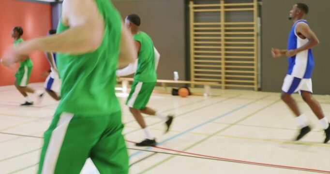 Man passing ball on court, rival intercepting, fast breaking and sprinting to defend, copy space