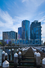Fototapeta premium Melbourne Docklands harbor cityscape with skyscrapers and water reflections on the Yarra River, Victoria, Australia