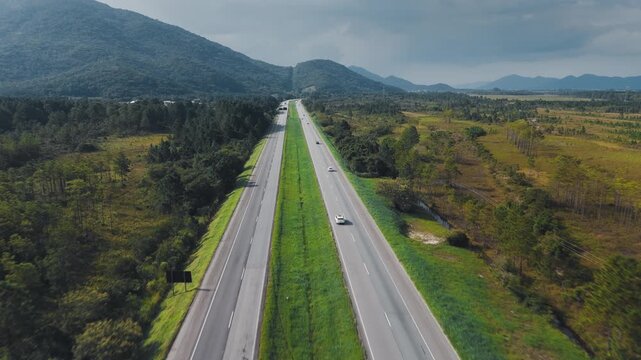 Aerial view of the straight highway BR101 in the state of Santa Catarina near the city of Florianopolis in Brazil
