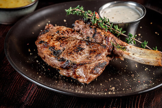 Juicy grilled bone in steak with creamy sauce