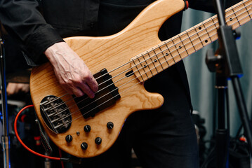 Fototapeta premium electric guitar in man hands, close-up view, young caucasian rock musician