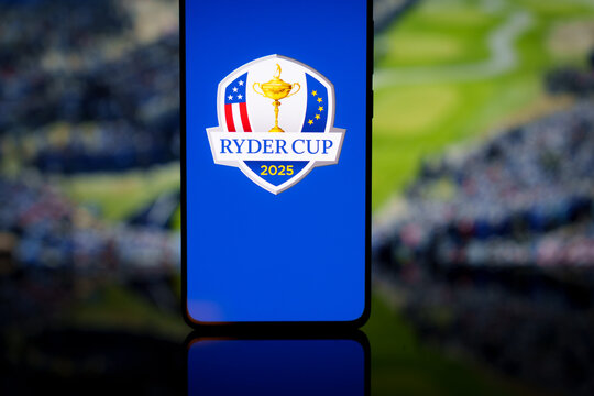 Ryder Cup 2025 logo displayed on a smartphone screen with a blurred golf course background, representing international golf competition and mobile sports broadcasting