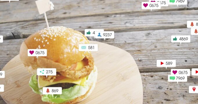 Vertical video: Floating badges moving from right over burger on wood board, showing rising likes