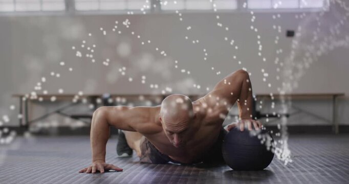 Coach holding plank pushing up and rolling med ball for fitness stability dotted arcs tracking ball