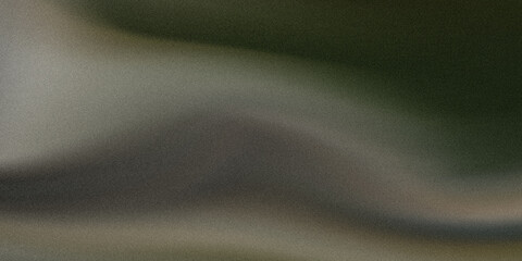 A blurred landscape featuring a faint silhouette of a mountain range against a soft sky, with a hint of vegetation in the foreground. © GMEgazul