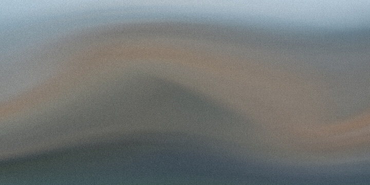 A tranquil scene of a mountain range silhouetted against a soft, hazy sky during dusk.