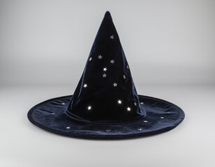 Fototapeta premium Dark Navy Blue Velvet Wizard Hat with Silver Stars on Grey Background – Magical Fantasy Object