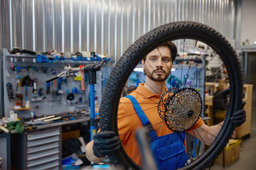 Fototapeta premium Mechanic carefully adjusts bicycle components