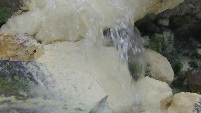 Close up view of the hot stream and sulfur sediments on the volcano of Mendeleev on Kunashir island. Russia