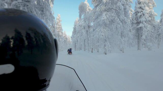 Embark on a thrilling snowmobiling journey through the stunning, snow-covered forests of Akaslompolo, Lapland. Experience the serene beauty of winter in Finland.