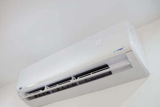 A white Carrier Optimax Plus wall-mounted air  