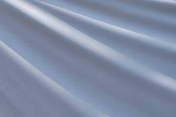 Fototapeta premium Textured, wavy surface made of waterproof gray-blue fabric covered with fine dew droplets.