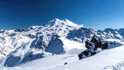 Fototapeta premium Majestic snow-capped mountains under a clear blue sky.