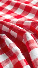 Fototapeta premium A close-up shot of a red and white checkered tablecloth with fabric folds.