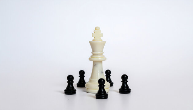 White chess king surrounded by black pawns on white background, symbolizing leadership and strategy in a game of chess.