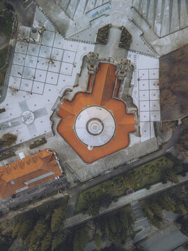 Aerial view of the Santuario de Nossa Senhora do Sameiro, its orange roof contrasting with the gray stone and geometric patterns below, Braga, Braga, Portugal.