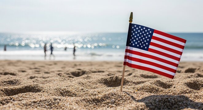 American flag planted in the sand on beach during summer day  