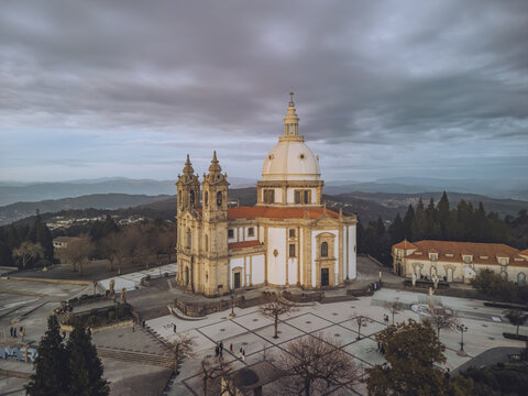 Aerial view of the Santuario de Nossa Senhora do Sameiro stands majestically against a backdrop of muted skies, its pale facade contrasting with the surrounding landscape, Braga, Braga, Portugal.