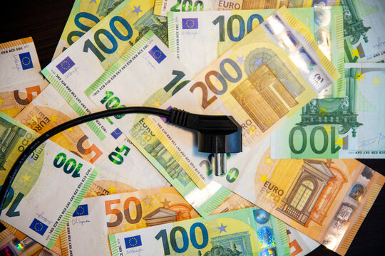 Save money with energy saving. Power cord and euro notes.