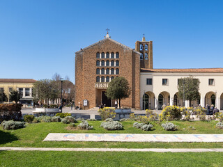 Fototapeta premium Chiesa di San Benedetto Abate, church of the '30s in a rationalist architectural style in Piazza Indipendenza of Pomezia, Italy