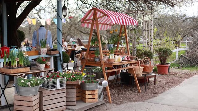 Easter exterior market stall with spring flowers, wicker baskets, bunny shaped candles, and festive decorations. Cozy outdoor garden shop with blooming plants in pots and seasonal holiday display.