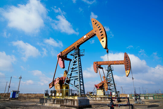 The oil pump, industrial equipment. Oil field site, oil pumps are running.