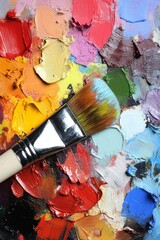 Fototapeta premium Colorful paint palette with brush for art projects and creative activities in a studio setting