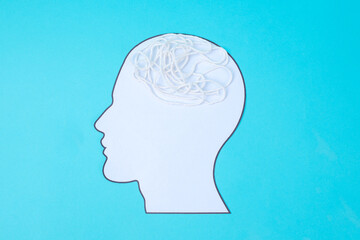 Obraz premium Mental Health Concept Showing Human Head Cutout With Messy Yarn Symbolizing Overthinking