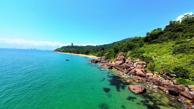 Cinematic FPV drone flight over Son Tra Peninsula in Da Nang, Vietnam, featuring tropical beaches, coastline and dramatic clouds from an immersive aerial perspective.