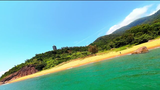 Cinematic FPV drone flight over Son Tra Peninsula in Da Nang, Vietnam, featuring tropical beaches, coastline and dramatic clouds from an immersive aerial perspective.