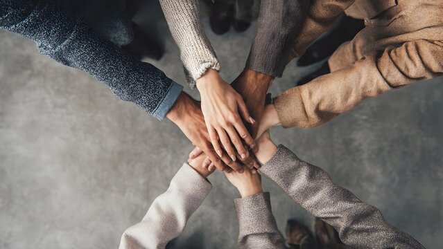 Ring of multiethnic colleagues&rsquo; hands stacked together to represent inclusive corporate culture and shared commitment