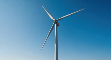 Fototapeta premium Majestic wind turbine dominates the expansive blue sky highlighting renewable energy and a sustainable future in Romania