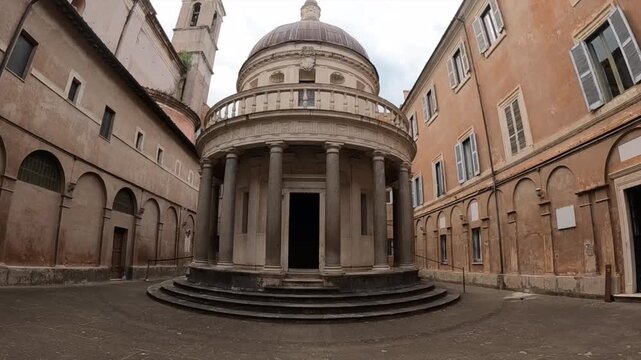 Stunning view of Tempietto di Bramante, iconic Renaissance circular church in Rome courtyard. Historic Italian architecture masterpiece with classical columns and dome in tranquil urban setting.