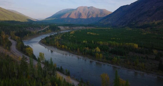 North Fork Flathead River and shaded mountains near Polebridge Montana, aerial drone scenic travel backdrop