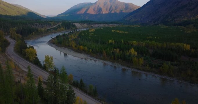 North Fork Flathead River winding along forested valley near Polebridge Montana outside Glacier National Park, aerial drone dolly
