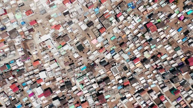Colorful tombs and graves in a traditional mexican cemetery seen from a high aerial perspective
