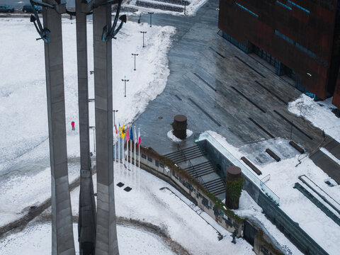 Aerial view of the Monument to the Fallen Shipyard Workers of 1970, standing tall against the snowy landscape, a stark reminder of history, Gdansk, Poland.